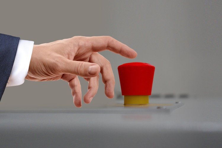 Showing a hand about to press a red button